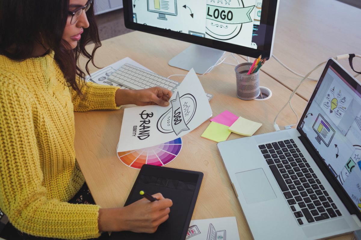 High angle view of young graphic designer working at office desk